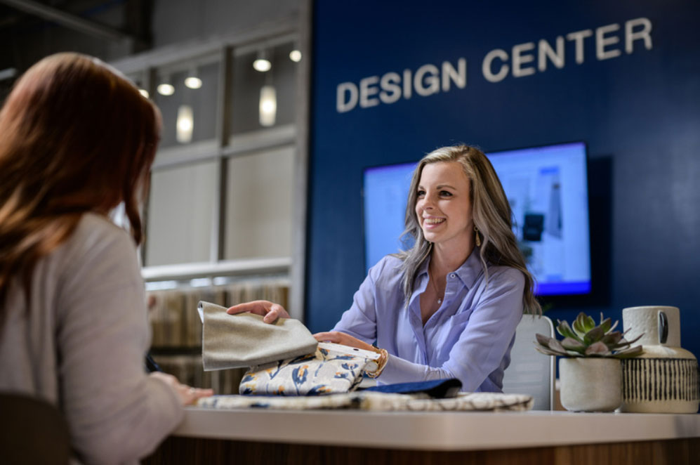 Woman showing a customer fabric samples.